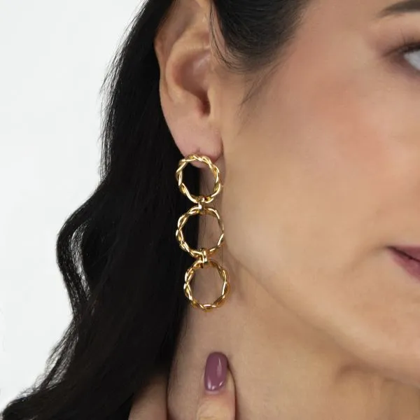 Gold-colored earrings with dangling torchon design
