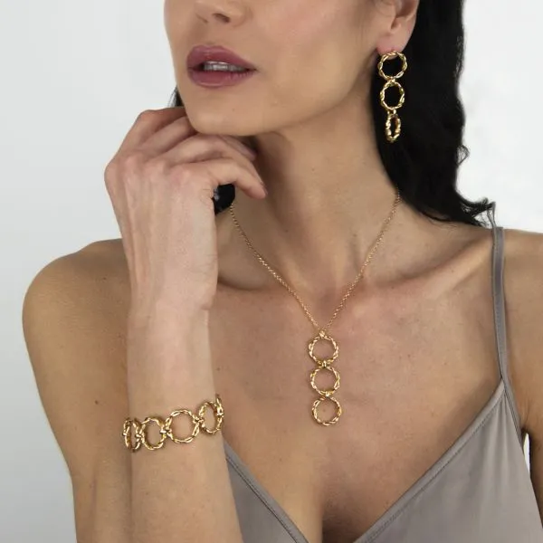 Gold-colored earrings with dangling torchon design